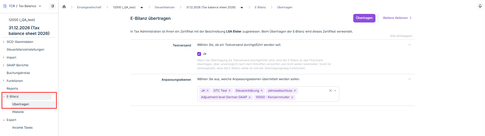 Zeigt die Seite 'E-Bilanz übertragen' in Tax Balance für die Steuerbilanz '31.12.2026 (Tax balance sheet 2026)' der Gesellschaft '12000 (_QA_test)', mit der Schaltfläche 'Übertragen', dem Menü 'Weitere Aktionen', dem Hinweis auf das zugewiesene Zertifikat 'LSA Elster', dem Abschnitt 'Testversand' mit dem aktivierten Kontrollkästchen 'Ja' und dem Feld 'Anpassungsebenen', in dem 'JA', 'GTC Test', 'Steuererklärung', 'Jahresabschluss', 'Adjustment level German GAAP' und '10000 - Konzernmutter' ausgewählt sind. Rot hervorgehoben ist der Eintrag 'E-Bilanz' in der Strukturansicht mit dem Untereintrag 'Übertragen'.